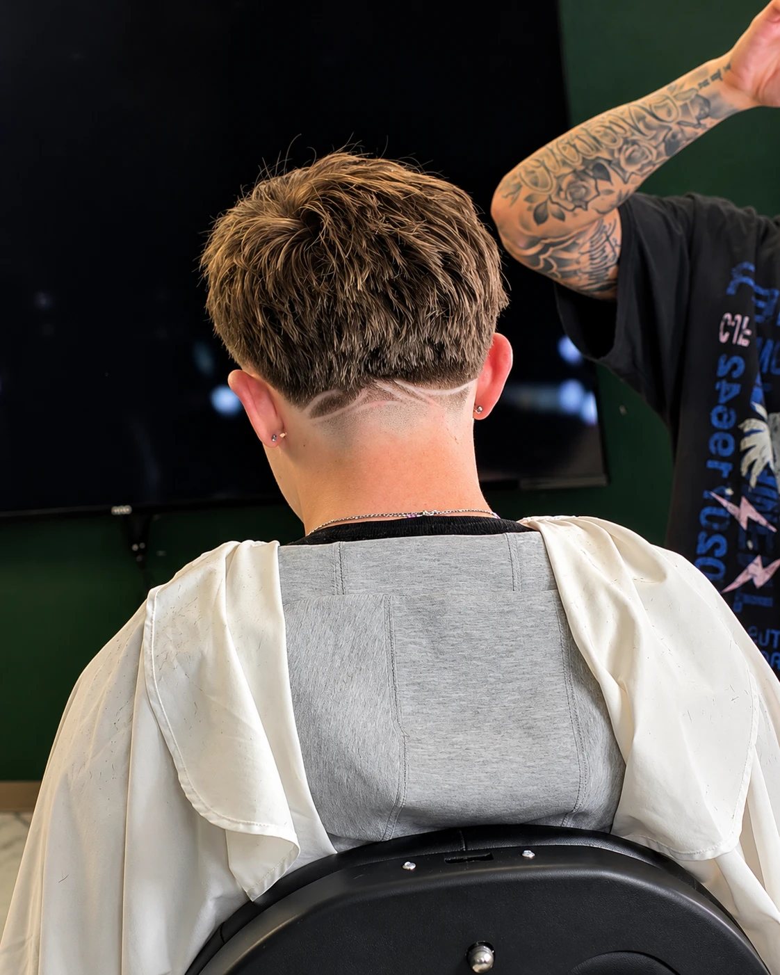 Textured cut with a curved line design shaved into the nape